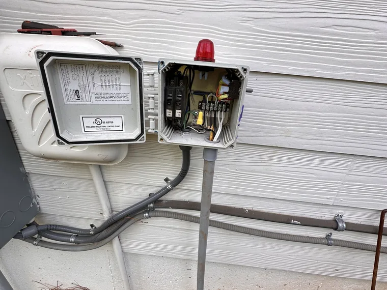 Septic pump control and alarm panel opened for service by SepticRooter™ in Woodstock, Cherokee County
