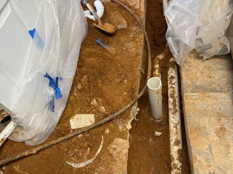 New under-slab PVC stub-ups and rerouted plumbing for a grease interceptor