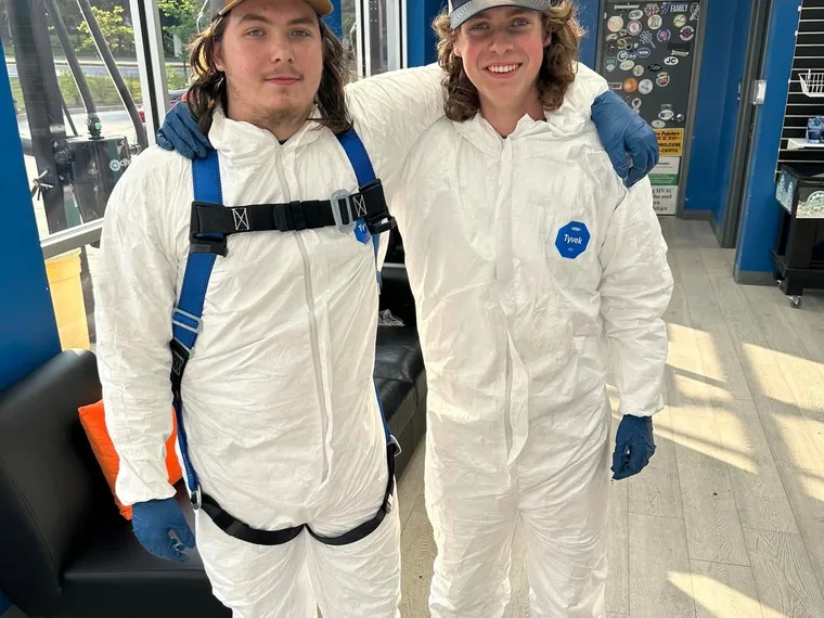 Two SepticRooter crew members in Tyvek suits and entry harnesses ready for a lift station job