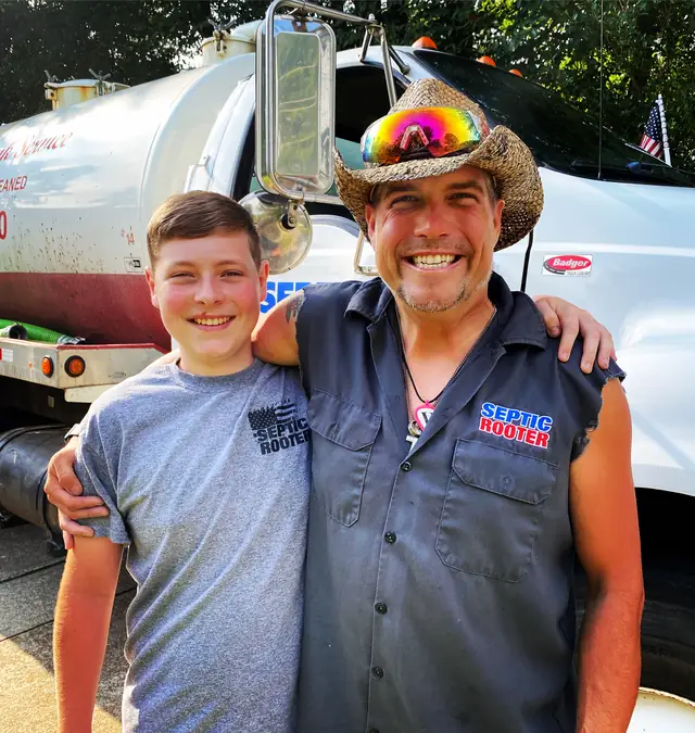 SepticRooter owner and son in front of a company truck
